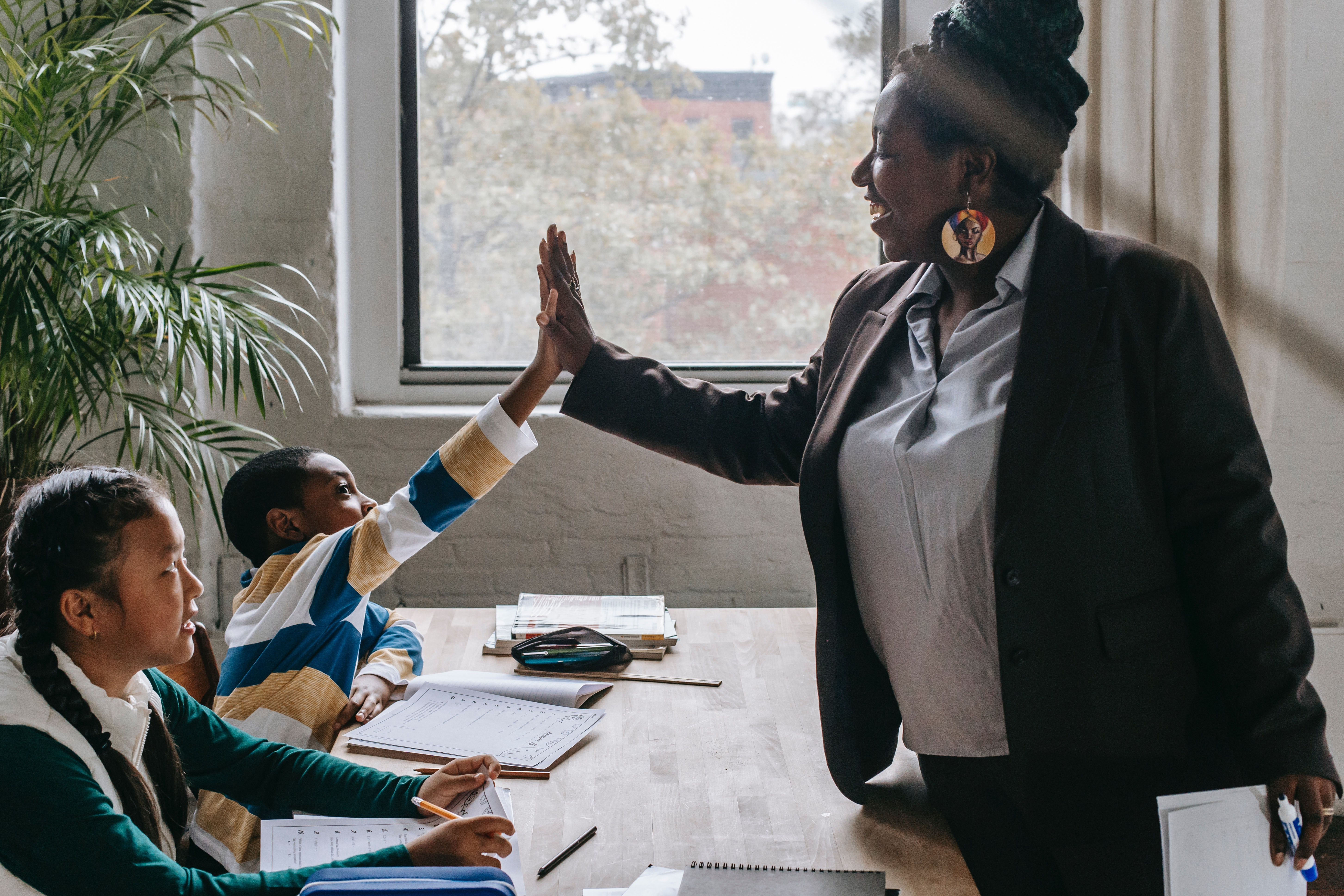 teacher high-fiving students 